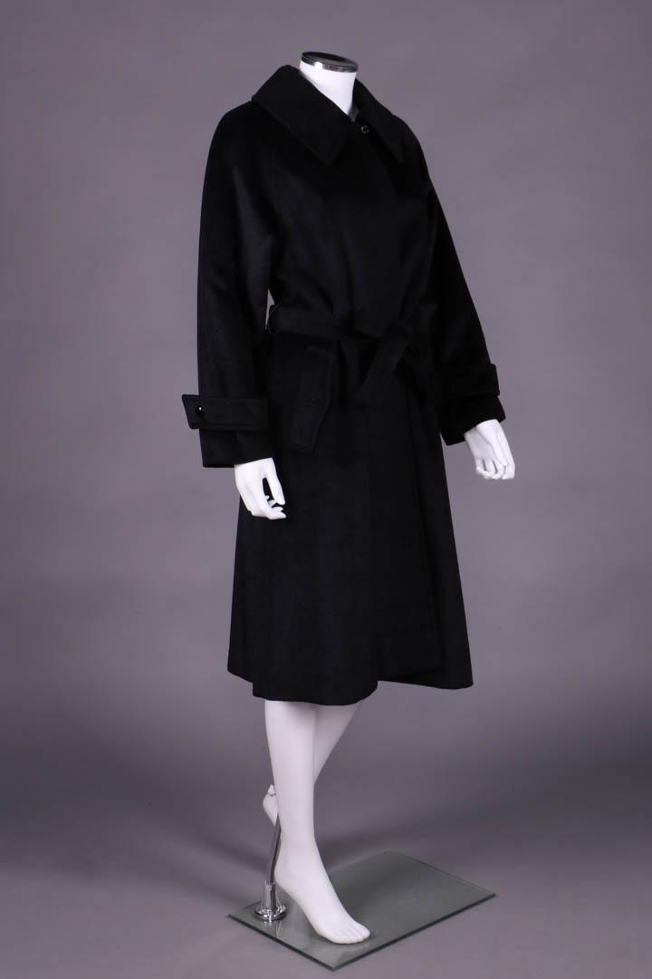 BLACK CASHMERE LILLI ANN COAT, SAN FRANCISCO, 1950s: Fitted trench coat w/ deep convertible collar, raglan sleeves, inset tab closure cuffs, inset front H pocket w/ decorative fold over buttoned tab, label "Lilli Ann of San Francisco", B 42", W 45", L 4
