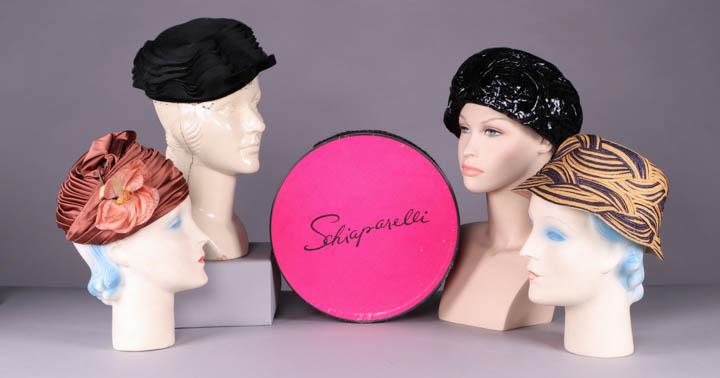 FOUR SCHIAPARELLI HATS, PARIS & AUSTRIA, 1950s: All label "Schiaparelli": 1 cinnamon wrapped turban w/ dusty pink silk rose, cream lace lining, circ. 22", size 7, Ht 5", (flower worn, tiny pulls) very good; 1 of black plastic ribbon manipulated int