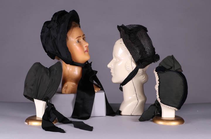 FOUR LADIES BONNETS, 1850-1880s: 1 ladies mourning bonnet w/ gathered & pleated festoon over crown, finely ruched ribbon edging, wide ribbon ties, c. 1850, inner brim circ. 18.5", (1 ribbon damaged, trim detaching & pinned in several