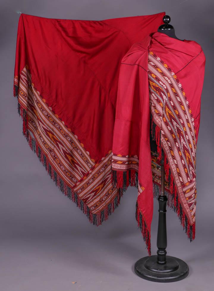 TWO SILK SHAWLS, TURKMENISTAN, 1920s: Both triangular w/ asymmetrically pieced, woven geometric large scale banned border in shades of yellow, white & black extending from vertex & tablet woven black & red fringe: 1 crimson, 209" x 50.5" 