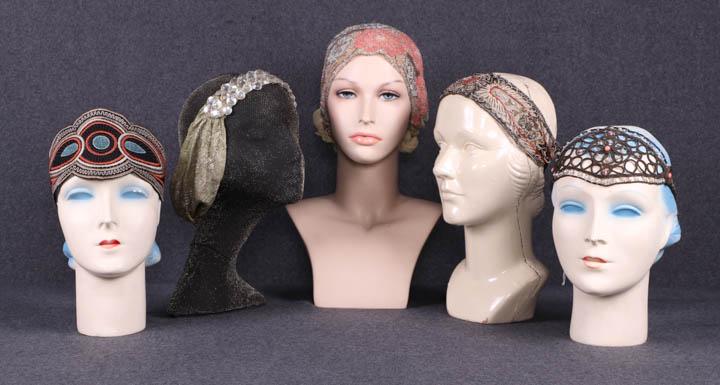 EIGHT HEADPIECES, 1910-1920s: 5 Headbands, 1920s: 1 appliqué converted to headband, Wd 4.25", L 60.25" w/ ribbon, 1 pale green lamé w/ rhinestones, Wd 1.5"-6.25", circ. 26.5", (discoloration, loose/missing rhinestones), 1 w/ flo