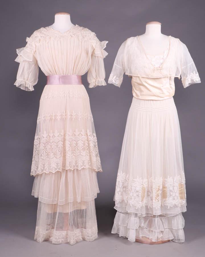 TWO TULLE TEA GOWNS, 1910s: 1 tea gown of silk tulle w/ embroidered floral & leaf motif to pleated SH top tiered skirt & at hem, pleated & gathered bodice, ruffle sleeve w/ SH, lavender sash, slip included, B 46", W 25", L 59.5"