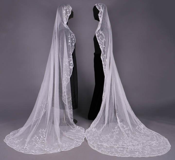 TWO OVAL EMBROIDERED OR TAPE LACE VEILS, 1890-1920: 1 w/ chainstitch embroidery on cotton tulle, 1890-1920, Wd 51 ", L 112", (light fraying at edges); 1 w/ tape lace appliquÃ©, possibly Belgium, early 20th C, 72" x 88", (few holes) both very good.