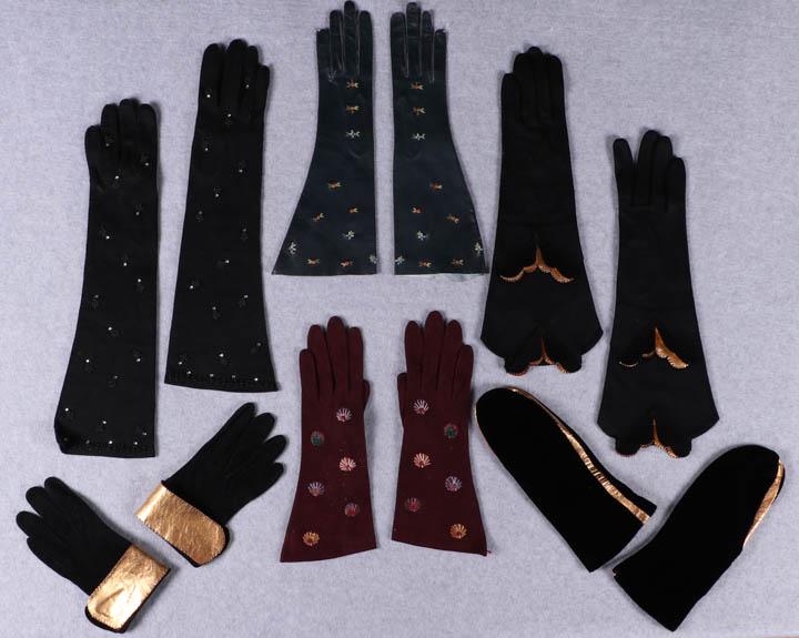 MITTENS & GLOVES, 1940s: All w/ palm circumference 5"-7": 1 black suede w/ gold cuffs, L 7", (sticker residue inside right cuff, wear to gold); 1 navy leather w/ embroidered flowers, L 12", (fingertip stitches fraying, sticke