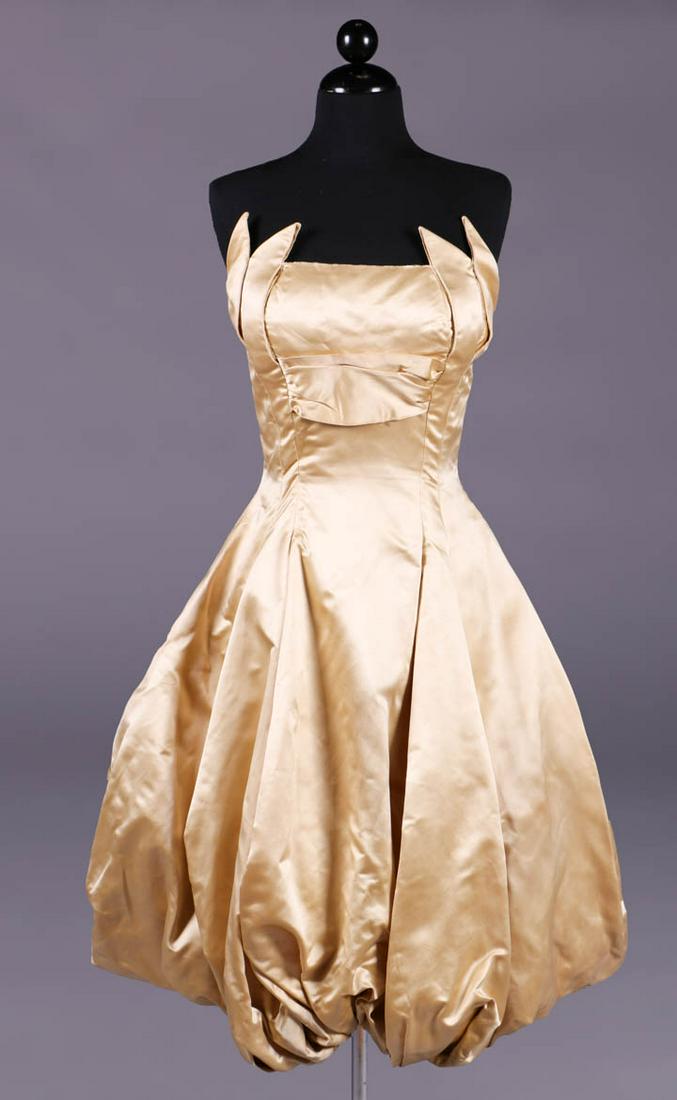 SIMONETTA FABIANI ATTRIBUTED GOLD EVENING DRESS, ITALY: Strapless princess cut tulip gown in heavy golden silk satin, fitted bodice w/ symmetrically draped & folded foliate petals embracing B, balloon skirt shaped w/ deep gathers at CF & CB hem, CB zip clo