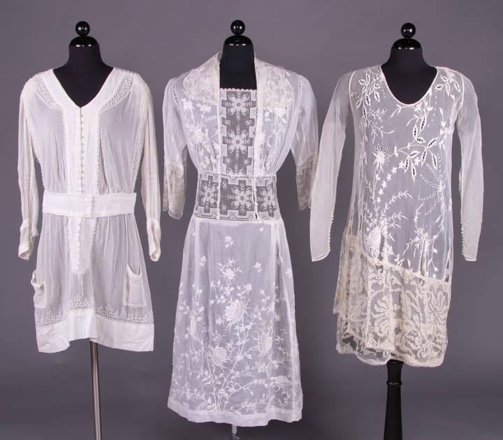THREE TEA DRESSES, 1912-1920s: 1 long sleeve cotton crepe tunic w/ vermicelli embroidery, wide yoke, CF panel, buttons, belt & hem of heavy boucle bark cloth, c. 1916, B 50", W 32", L 38.5", (2", 3" & 2.5" holes & wear W, faux belt