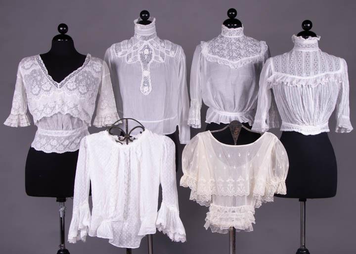 SIX LACE BLOUSES, 1905-1912: 1 Val lace & cotton tulle V-neck, B 40Â”, W 31.5", L 20.5", (1.25" hole in top layer of net right SH); 1 handkerchief linen embroidered yoke & lace insertions, B 42Â”, W 26.25", L 18.5", (0.75" 