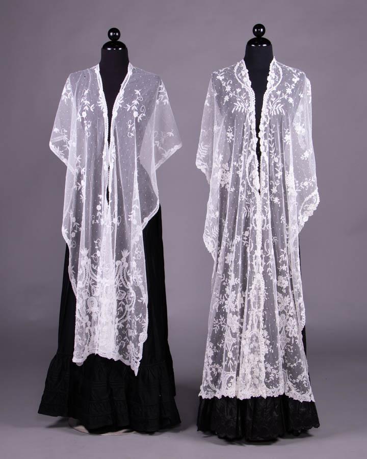 TWO LACE APPLIQUÉ SHAWLS, 1870-1880s: Both tulle w/ applied tape lace, fagoting & chemical lace insertions: 1 w/ pseudo vase motif for large bouquet at centers of ends, 19" x 118.5", excellent; 1 w/ baroque motifs, 15” x 110", (several 