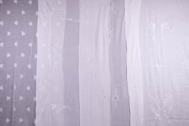 ELEVEN LENGTHS OF PRE-EMBROIDERED UNCUT YARDAGE: 1900-1920: 1 Indian embroidered w/ drawn thread work down center, 30.5" x 64.75", (6" x 2" swatch removed from center, light stains); 1 Chinese embroidered in grape vine motif, 39.5" x 87"; 1 flounce 