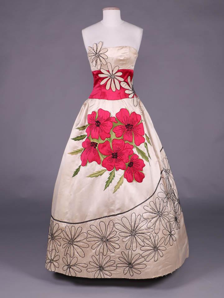 EMILIO SCHUBERTH EVENING GOWN, ROME, c. 1953: Strapless cream silk satin evening gown w/ inset cerise midriff overlaid w/ cream daisy appliqués outlined in black faceted & mini bugle beads, cerise satin poppy bouquet appliquéd to front of skirt