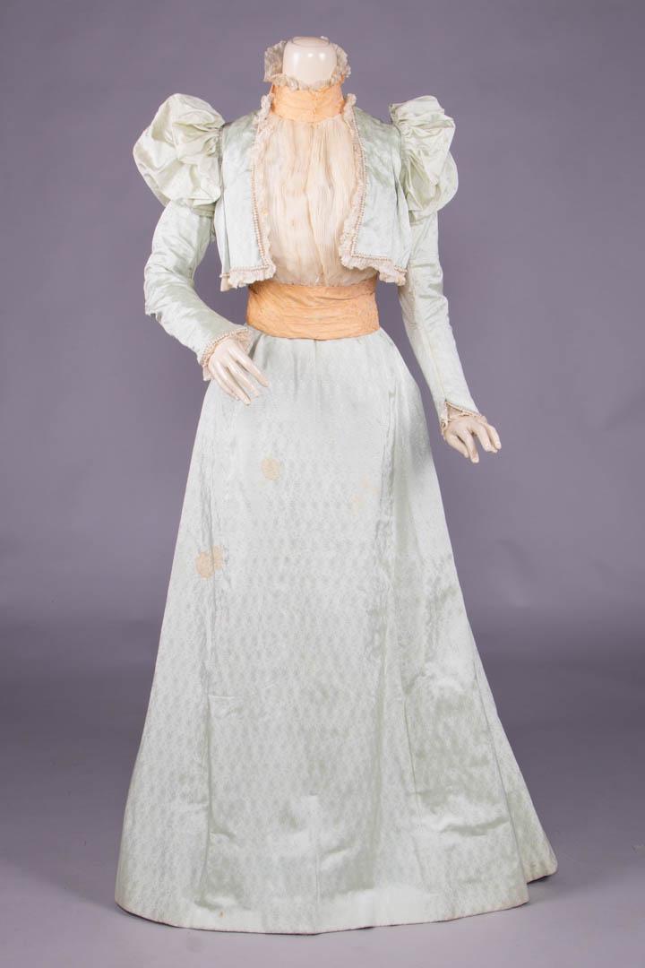 MARIE ROBEL PATTERNED SILK FAILLE PROMENADE GOWN: 2-pc pale celadon patterned silk faille fitted bodice w/ bolero style front edged in pleated silk chiffon, pearls & silvered glass beads, 2-pc fitted sleeve w/ large SH puff, pleated standing collar o