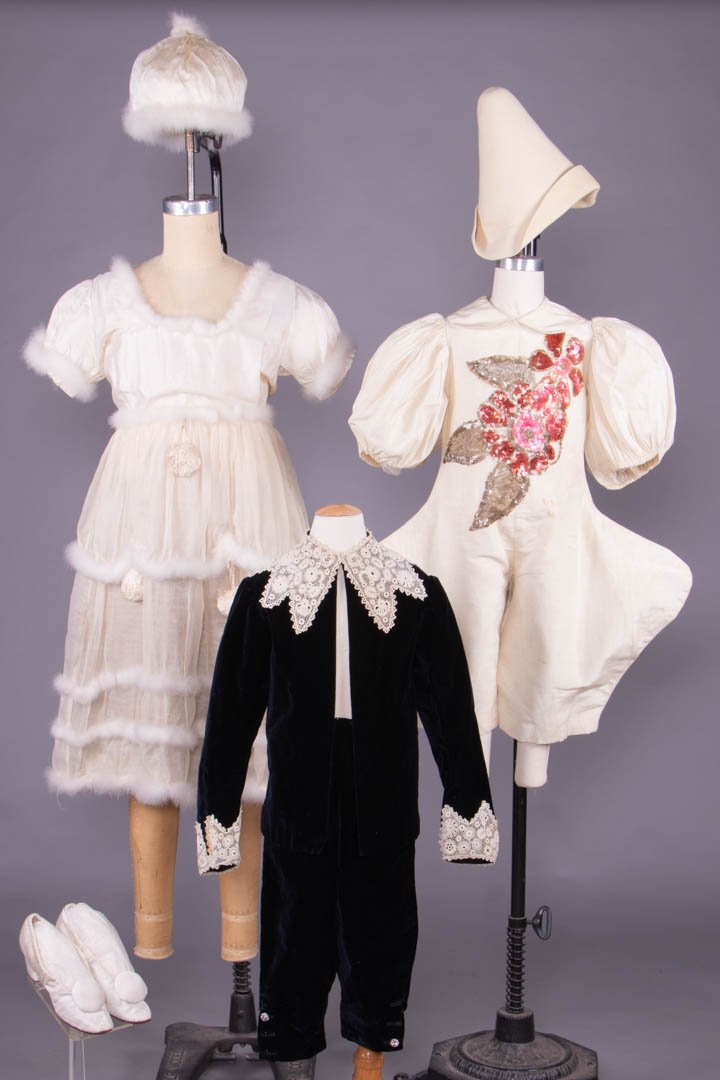 THREE CHILDRENS FANCY DRESS COSTUMES, LONDON, 1910-1920: 1 child’s commedia dell’arte Pantellone jumper w/ sequins & white felt cap, CH 26", L 28.5", cap Ht 9", circ. 23.25", size 7 3/8, (sequin loss, staining, seam right back undone, cap misshapen); 1 