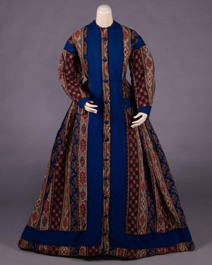 WOOL CHALLIS WRAPPER, 1850s: Blue & brown Kashmir inspired stripe challis, self covered CF bone button closure, 2-pc sleeves w/ cuff & SH blue wool insets, 2 patch pockets at CF H, fitted back W band w/ complex box pleats to full