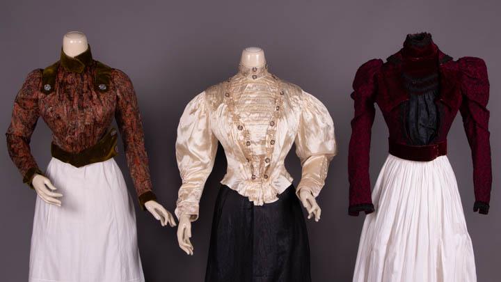 THREE DECORATIVE BODICE, 1899-1905: 1 patterned silk w/ floating feather motif on chine ground, green velvet collar, cuffs, asymmetrical shaped W band & epaulette inspired SH ornaments, faux cloisonné buttons w/ imitation marcasite