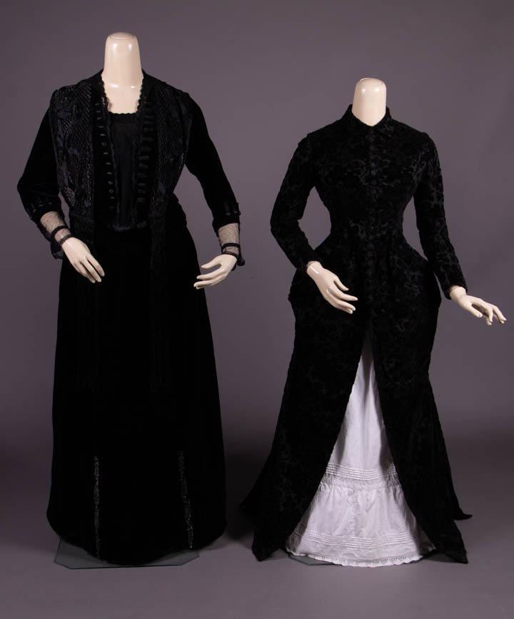 ONE ENSEMBLE & ONE BLACK VELVET BODICE, c. 1880 & 1910s: 2-pc black velvet & beaded gown, military inspired sleeved bodice w/ net CF panel trimmed w/ row of buttons & faux frogs, cuffs & faux vest, jet beaded & embroidered floral lace overlay w/ asymmetrica