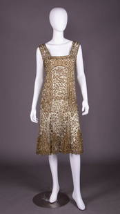 HOUSE OF ADAIR LAMÉ EMBROIDERED PARTY DRESS, MID 1920s: Green silk tulle party dress heavily embroidered in silver, gold, & bronze metallic thread in stylized florals & border bands w/ square neckline, illusion draped vest front & back flared skirt, embroi