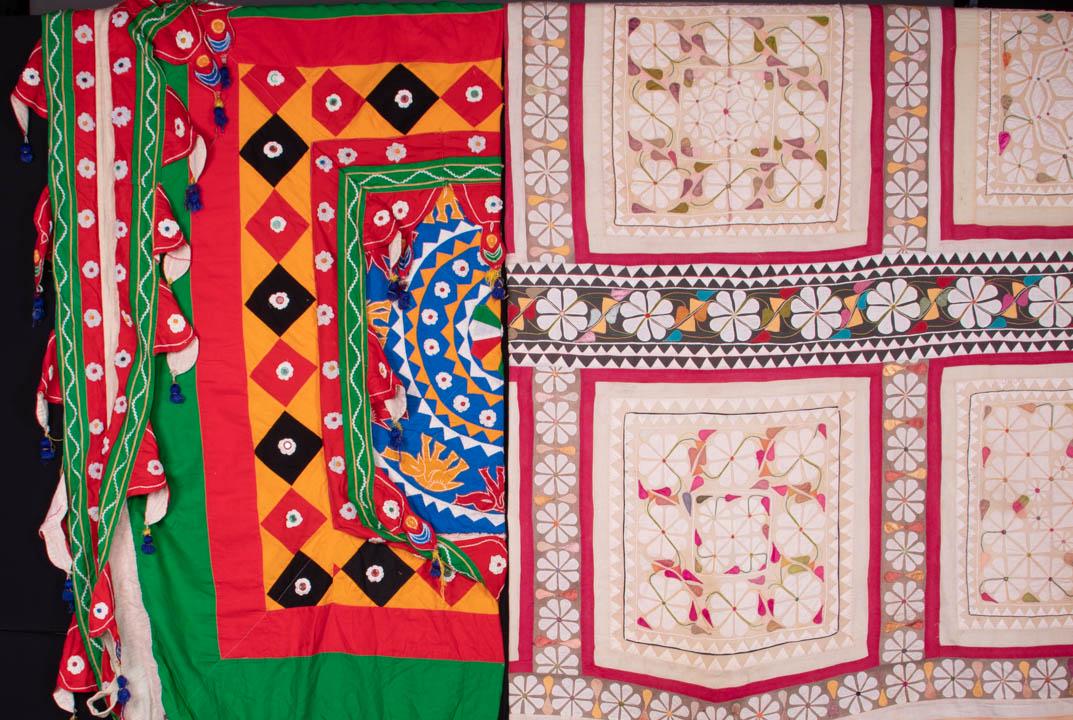 TWO CEREMONIAL CANOPIES, INDIA, 20TH C: 1 cream, brown & pink Shamiana (wedding) tent hanging w/ appliquÃ© & embroidery, inset borders, 82" x 134", (discoloration/fading throughout, small scattered holes & stains, wear to edge loops, 2 ru