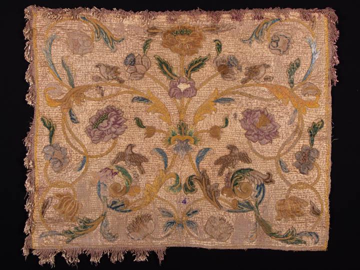 EMBROIDERED & APPLIQUÃ‰D FURNISHING PANEL, ITALY, 1700: Furnishing panel of course woven hemp overlaid w/ couched silk thread ground, petit pointe & fine canvas embroidery w/ silk floss appliquÃ© w/ raised work elements, looped fringe w/ fine shaped silk