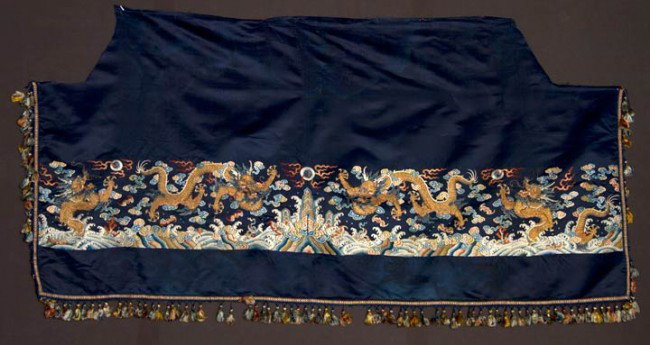 EMBROIDERED HORIZONTAL DRAGON PANEL, CHINA, 1800-18: Midnight blue silk ground, wide polychrome silk & metallic gold finely embroidered band, temple at center seam w/ flaming pearl above, bordered by finely shaded waves w/ bats, above are 2 pair large c