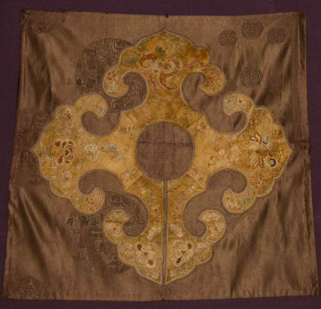 EMBROIDERED IMPERIAL COLLAR, CHINA, 19TH C: Intricate patterned silk needlework, gold maze ground w/ ivory, pale blue, brown & black flowers having couched gold outlines, collar stitched onto mushroom brown silk damask, 30" x 31", excellent.