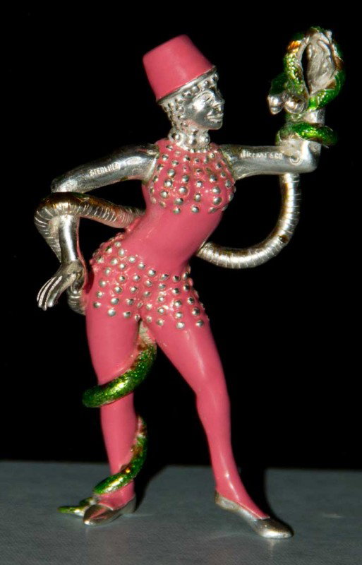 TIFFANY STERLING FIGURINE, MID 20TH C: Marked "Tiffany" & "Sterling" painted enamel figurine of lady snake charmer (little wear to green enamel on snake) very good; t/w 1 sterling marked bell, very good.