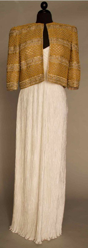 MARY McFADDEN EVENING GOWN & JACKET, LATE 1970s: White silk pleated evening gown, empire bodice w/ spaghetti straps, gold boxy jacket, alternating horizontal bands of metallic gold macrame cord & delicate gold & silver beading, gown size 12, jacket 