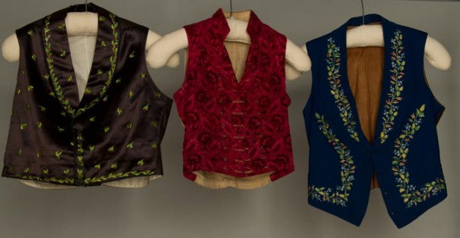 THREE MEN'S SHORT VESTS, 1800-1869: 1 1800-1815 Spanish, cranberry cut & uncut velvet floral & leaf pattern, linen back, floral printed cotton facing; 2 w/ shawl collars & polychrome silk embroidery: 1 1800-1825 Yugoslavian in cadet blu