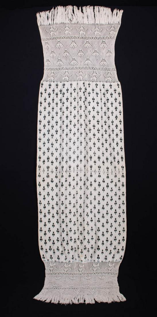 PANO MANO IKAT SHAWL, CUENCA, ECUADOR, 20TH C: Pano Mano Ikat shawl w/ deep ends in bird & palm motifs in openwork macrame type knotting & fringe, Cuenca, Ecuador , Wd 21"-30", L 100", (many tiny-0.5" stains, fringe messy, tiny pulls) very good.