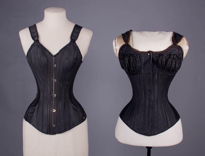 TWO BLACK COTTON CORDED CORSETS, AMERICA, 1892 & 1883: 1 glazed black cotton sateen w/ corded geometric B panels, steel busk front closure, adjustable SH straps w/ button closure, w/ original lacings, stamped "Kabo Style 201, Pat. Feb. 23 '92", B 27", W 1