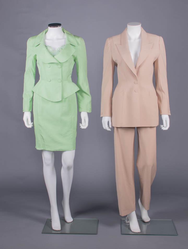 TWO THIERRY MUGLER SUITS, PARIS, 1980s: All w/ label "Thierry Mugler Paris, Made in France": 1 pale green rayon blend skirt suit c/o fitted faux double breasted jacket w/ self covered decorative buttons over snap closures, original removabl