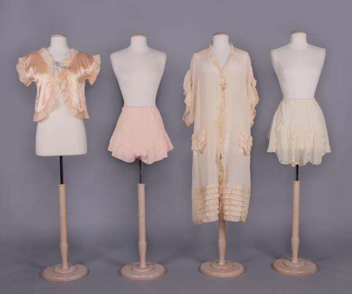 SILK BED JACKET, ROBE & TAP PANTS, 1920-1930s: 1 peach silk satin bed jacket w/ mm lace to neckline, CF opening & short sleeves, CF satin ribbon ties, CH 39", L 18", (light discoloration, 1 set of ribbons replaced, few small stains/holes); 1 cream