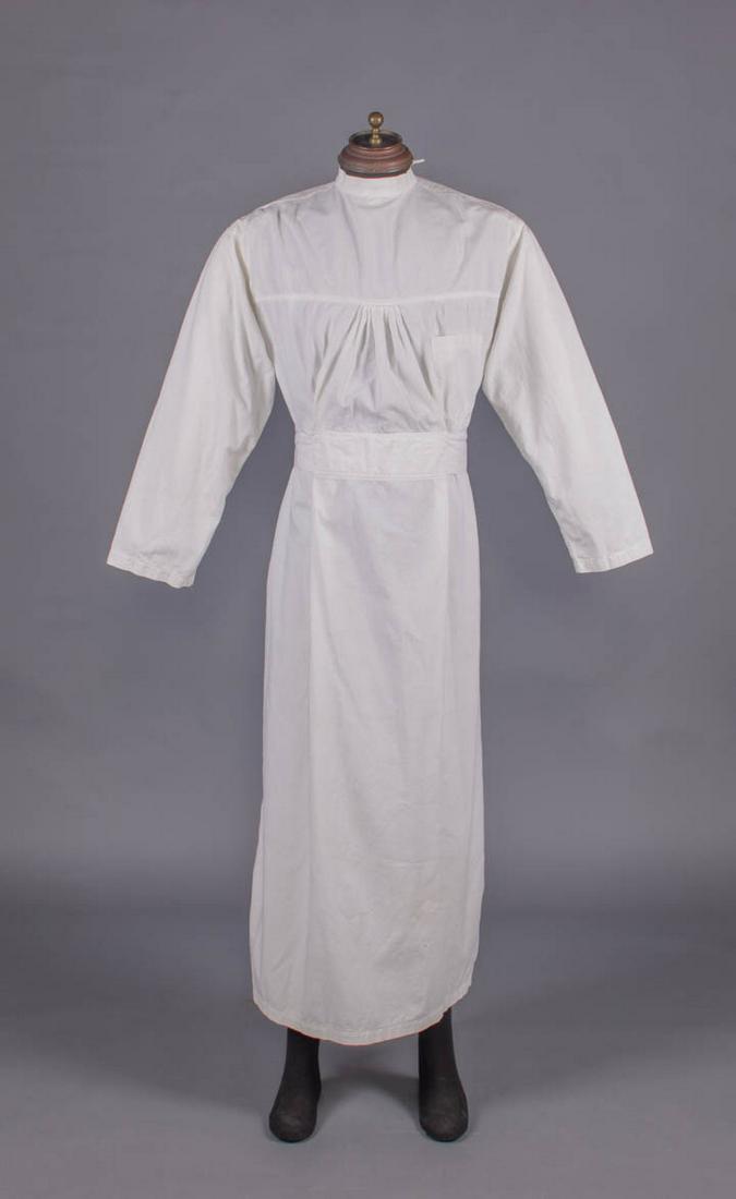 WHITE COTTON SURGICAL GOWN, 1950s: White surgical gown w/ band collar, broad yoke, single B pocket, CB tie closures, fitted W band into CB tie, label "Medium MD-USA”, size 16, CH 54', L 56.5", (light wear, few spot stains & tiny 