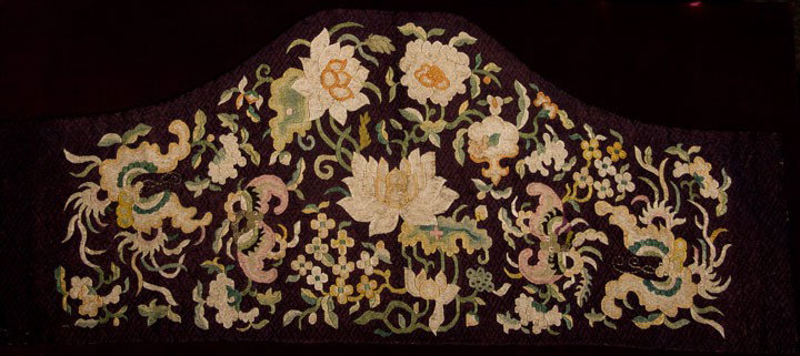 SILK EMBROIDERY, CHINA, QING PERIOD: Hand embroidery in alternating length stitches w/ pastel colored silks on black embroidered diaper pattern ground, design w/ lotus blossoms & smaller flowers in center, on each side 2 large bats, 14" 