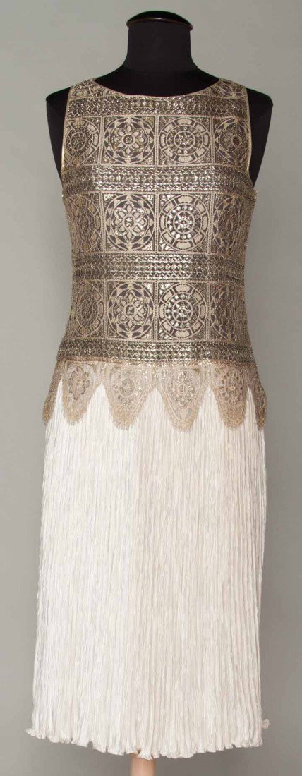 MARY McFADDEN PLEATED DRESS, 1970-1980: Beige & silver metallic m.m. Reticella lace bodice attached to ivory pleated skirt, labeled, B 36", H 36", L 45", excellent.