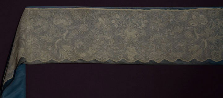 LONG LACE ALB FLOUNCE, ITALY, c. 1750: White drawn work & embroidery in fine linen thread, diaper pattern ground & large scale design of flowers, grapes & wheat ears in formal repeat, 10" x 4+ yards, excellent. Estate of Marion Powys, reno
