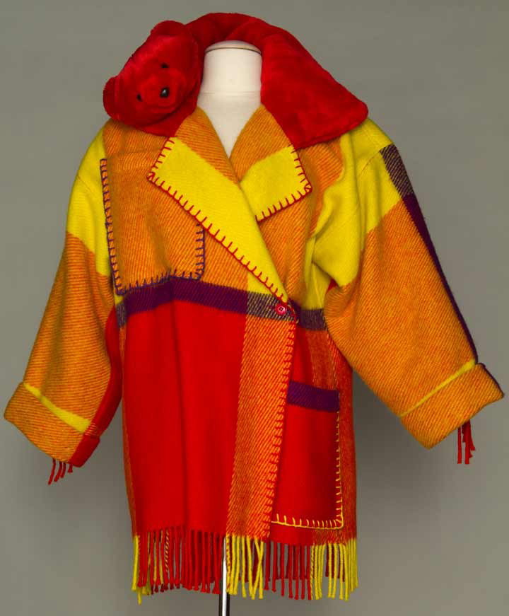 CASTELBAJAC WOOL COAT, LATE 20TH C: Large scale lipstick red, bright yellow & purple plaid wool 3/4 L coat, red plush collar w/ 1 stuffed teddy bear head, 2 large patch pockets w/ yarn blanket stitch edging, 3.5" fringe on hem & sleeves