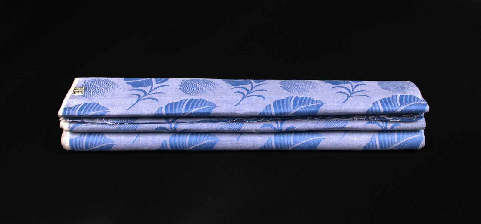 WIENER WERKSTATTE DEADSTOCK YARDAGE, c. 1930: Linen yardage in shades of lavender & blue complex damask weave in exotic flora motifs, label "WW Wien Entwurf Marke, Muster Geschutzt", 48" x 119", (stains at fold marks, light staining throughout, 1