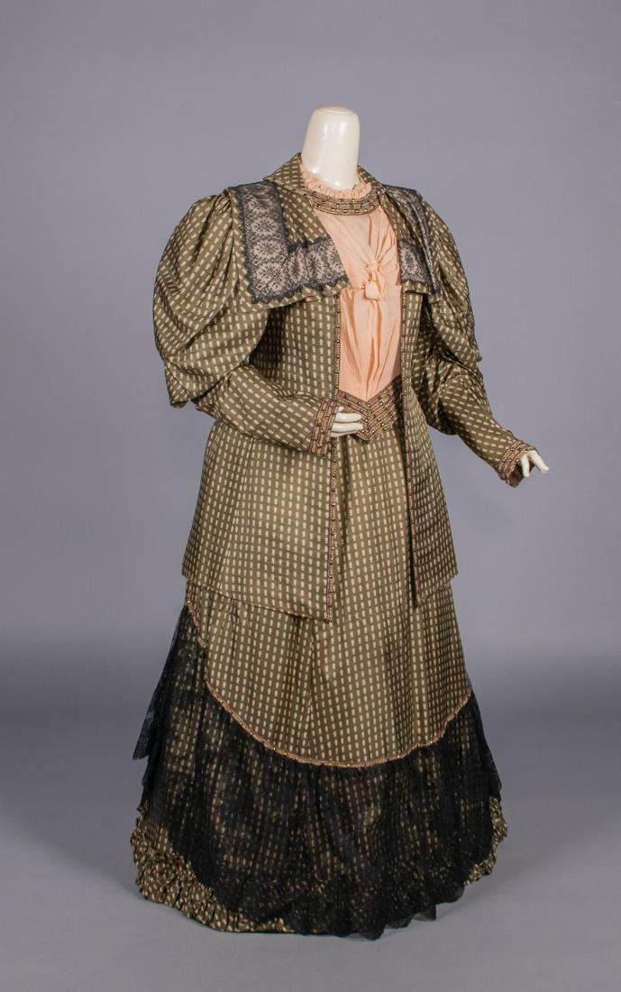 PRINTED SILK DAY ENSEMBLE, c. 1908: 2-pc resist printed silk twill c/o extended coat bodice edged w/ facetted stones & garnet, pearlized & metallic glass seed beads, Chantilly lace insertions to draped square extended collar, pink china