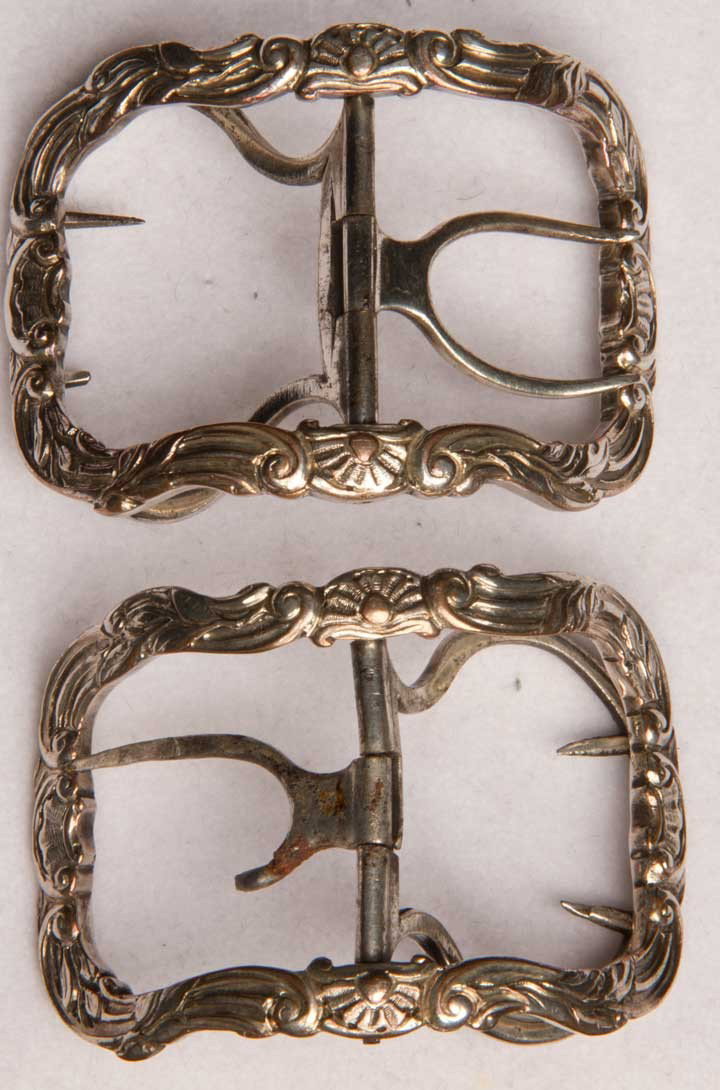 PAIR SILVER SHOE BUCKLES, ENGLAND, 18TH C: Sterling pair, ornate curvaceous frame, 1.5" x 2.5", (1 buckle w/ higher curve & 1 broken prong) very good. MCNY