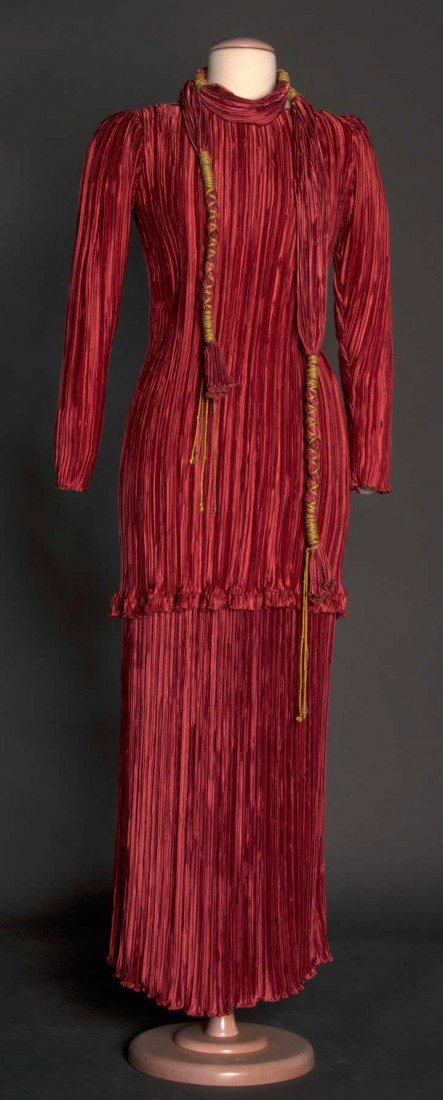 MARY McFADDEN EVENING GOWN, c 1980: Dark rose 2-piece pleated skirt, long sleeve tunic & belt w/ gold cord, labeled, top marked size 6, L 32", skirt marked size 8, L 39", excellent. FIDM