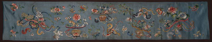 EMBROIDERED SILK PANEL, CHINA, EARLY 20TH C: Blue grey silk satin, silk polychrome embroidery in variety of intricate stitches, designs of vases, flowers, bats & plum blossoms, 14" x 76", (light stains in satin) very good.