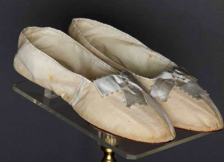 PAIR LADY'S SHOES, HAVERHILL, MA., 1820s: Ivory velvet slipper-style, round toe & white sillk ribbon, paper label "Kimball & Foster Haverhill, Mass", 2.5" x 8.75", (minor discoloring) very good.