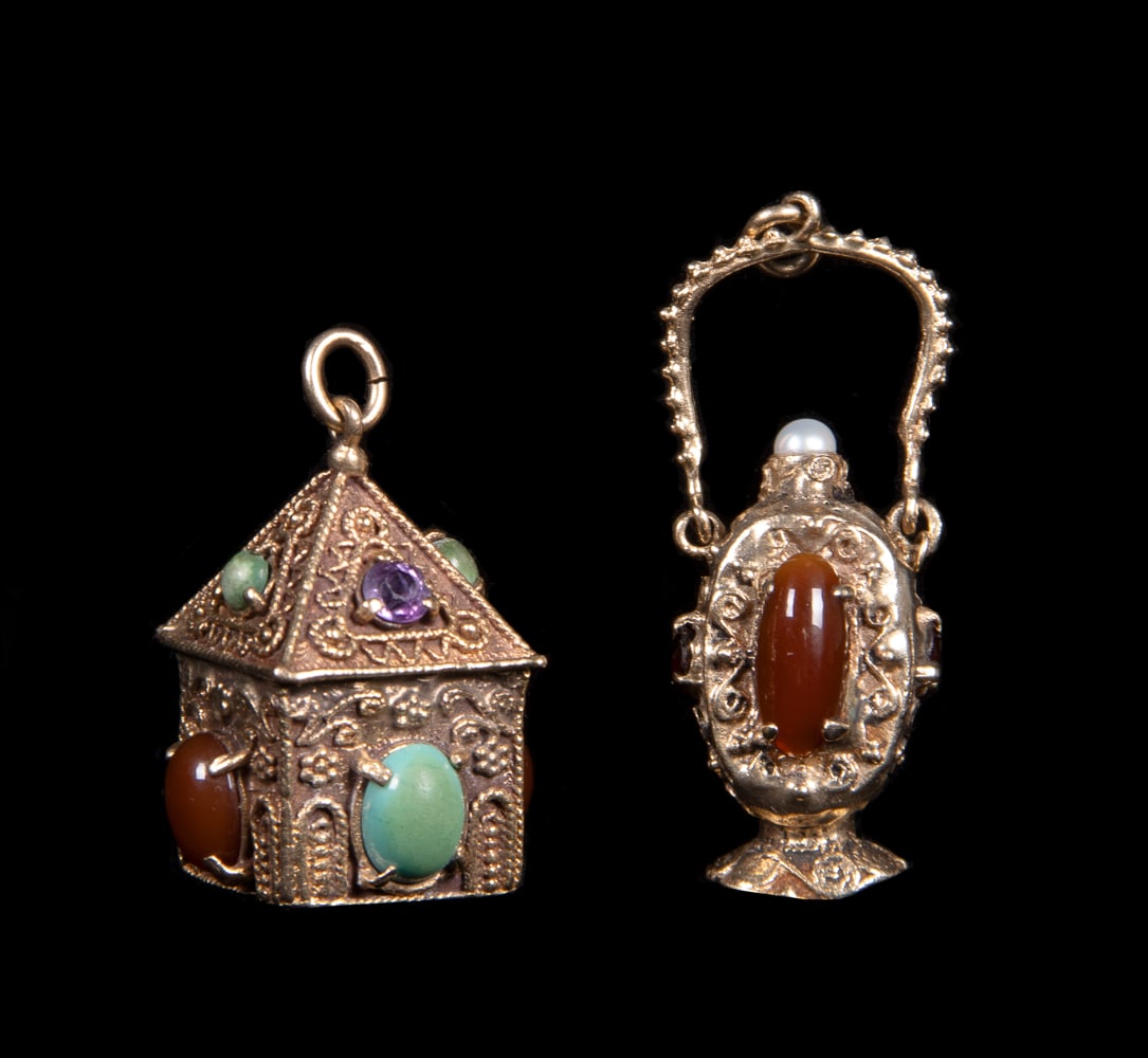 TWO 14K GOLD AMULET FOBS, LATE 20TH C: Both stamped â€œ14K” gold & w/ cabochon stones: 1 house shaped w/ turquoise, carnelian & amethyst colored cabochons, 1.25” x 0.75”, Wt. 18 g, (minor tarnish, few stones discolore