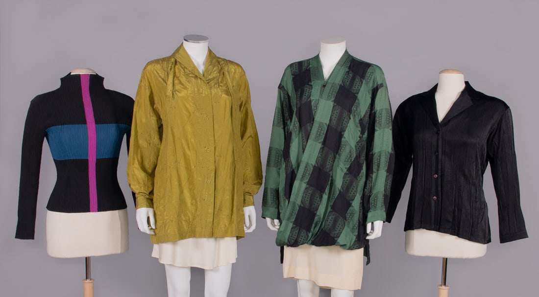 FOUR ISSEY MIYAKE SHIRTS, JAPAN, 1985-2000: All w/ label â€œIssey Miyake”: 1 black synthetic turtleneck w/ horizontal blue band & narrow vertical pink stripe from neck to front hem, 1998, B 32”, L 21”, (small hole right SH