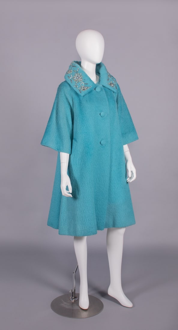 LILLI ANN EMBROIDERED WOOL COAT, USA, 1960s: Turquoise wool shag w/ iridescent seed beads, sequins, faux pearls & teardrop shaped blue faceted rhinestones to deep shirt collar, 3 large self-covered CF buttons, glove length sleeves, lined in silk