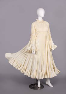 ANNE FOGARTY EVENING DRESS, USA, c. 1970: Cream pleated synthetic crepe evening dress w/ narrow pierrot collar, empire W & elbows w/ applied cream velvet ribbon tied into bows at CF, CB waist & elbows, circular lower sleeve & skirt edged w/ p