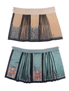 TWO EMBROIDERED MANDARIN PAIRED SKIRTS, CHINA, c. 1875: 1 heavily embroidered ecru patterned silk w/ plain & embroidered black silk bands, c. 1875, W 45”, L 38”, (minor discoloration, few pulls/small holes, some loose stitching, lining worn/fra