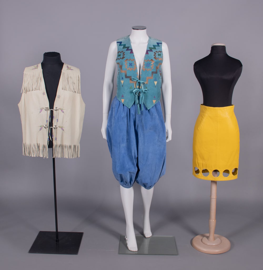 DESIGNER & ARTISAN LEATHER SEPARATES, ITALY & AMERICA, 1980s: 1 bone colored calf skin leather vest w/ scored & painted wheat motif, Southwestern style metallic buttons w/ paired fringe ties, label “Made in Canada by Jos Binne”, SH-SH 16”, CH 48&rd