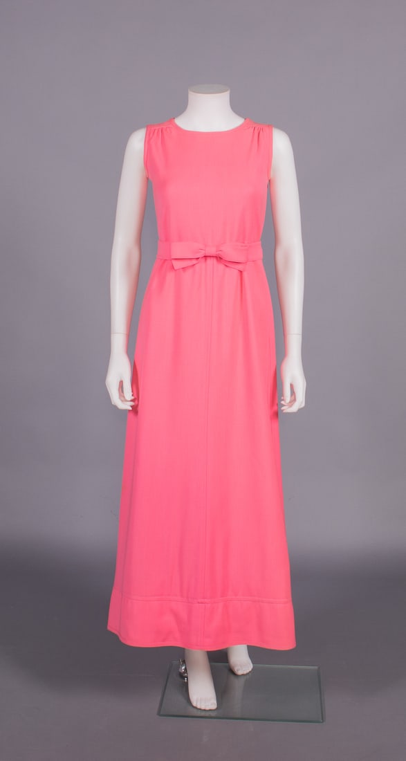 COURREGES WOOL EVENING DRESS, LATE 1960s: Sleeveless hot pink wool dress w/ gathers at SH, self-waistband w/ flat bow at CF, lined in white silk, label "Courreges Paris Couture Future", B 34", W 26", L 53", (lining discolored, hem shortened,