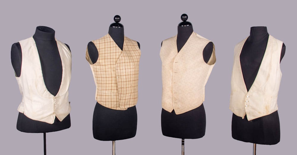 FOUR COTTON OR SILK WAISTCOATS, 1860-1915: 1 brown & cream basketweave w/ twill windowpane check, treated cotton backing, 1860s, CB buckle stamped “Pat. July 30, ‘89”, CH 36”, L 21”, (closures missing, uneven glaze or iro